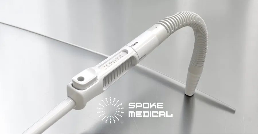 Zephyr microsuction handpiece with its tubing curved into a loop on a steel surface